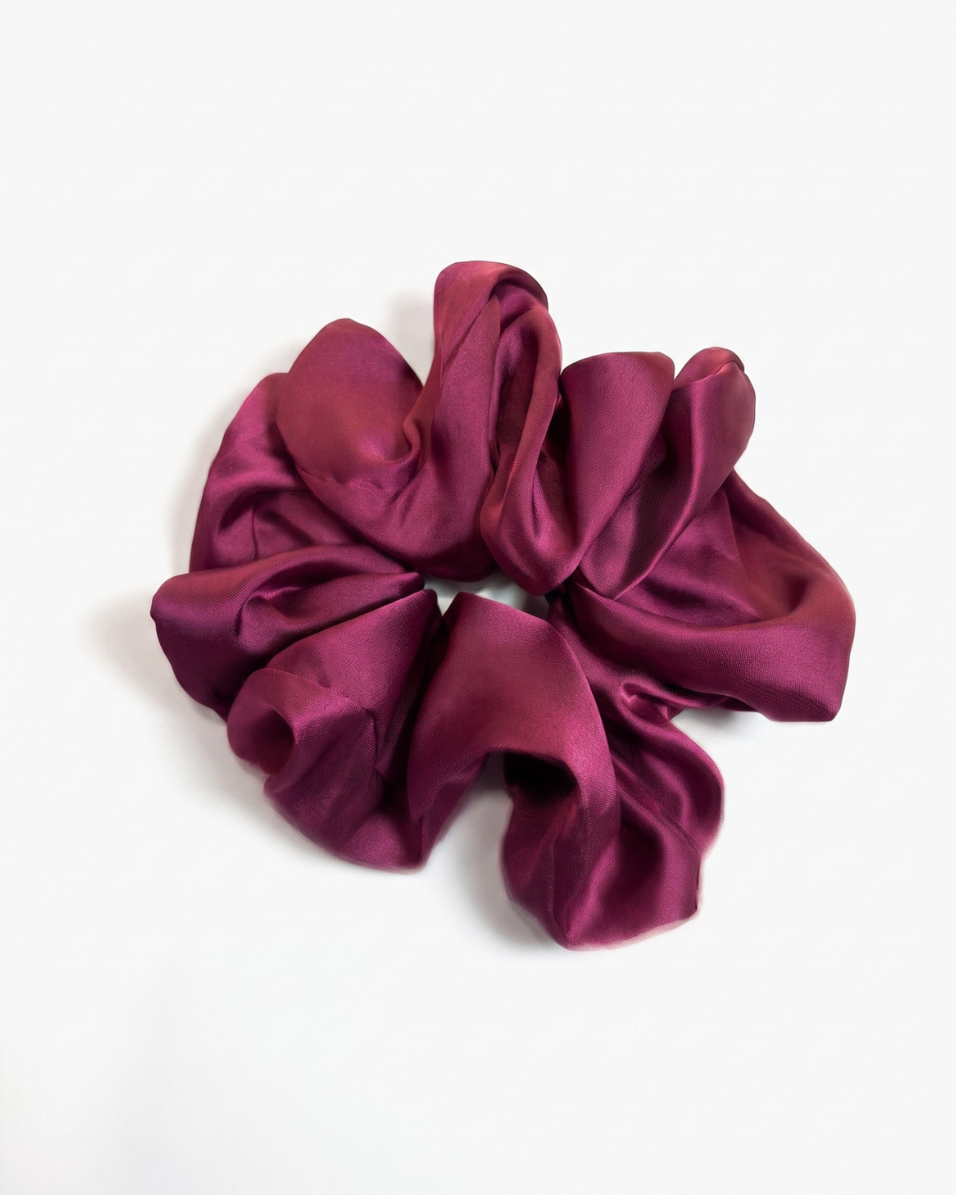 Burgundy satin scrunchie with a soft, oversized design for gentle hair styling and everyday wear.