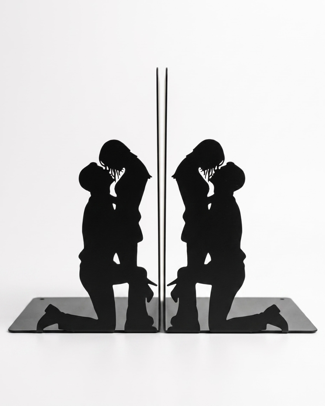 Metal Book ends featuring a man on his knees and a woman looking down