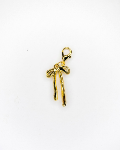 Golden charm with lobster hook showing a thick golden bow