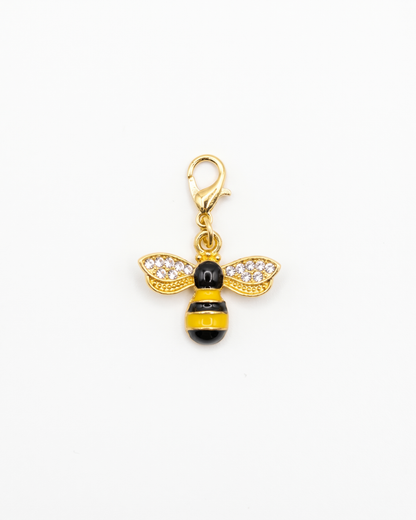 Golden and zirconia charm with lobster hook showing a yellow and black honey bee with zirconia on the wings