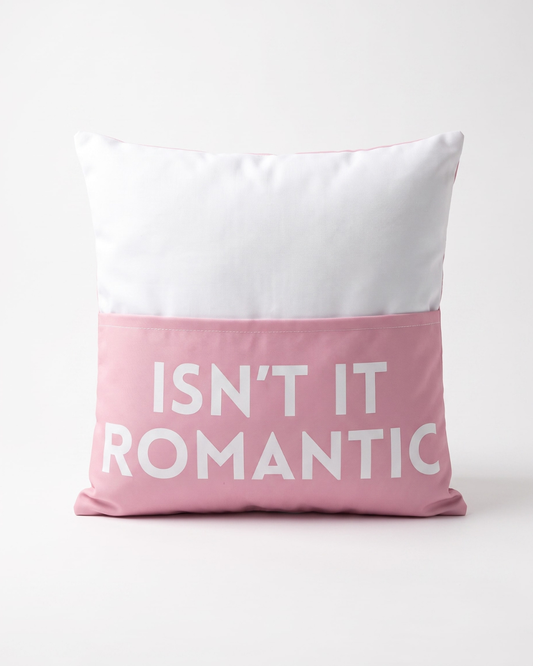 Pink and white decorative cushion cover featuring the phrase "Isn't It Romantic" on the pocket on the front