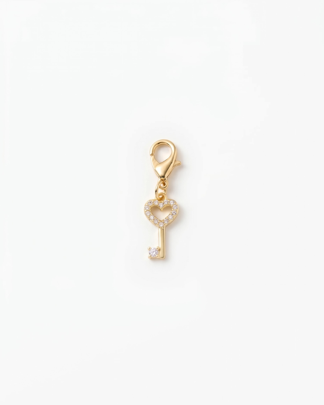 Golden and zirconia charm with lobster hook showing a heart key