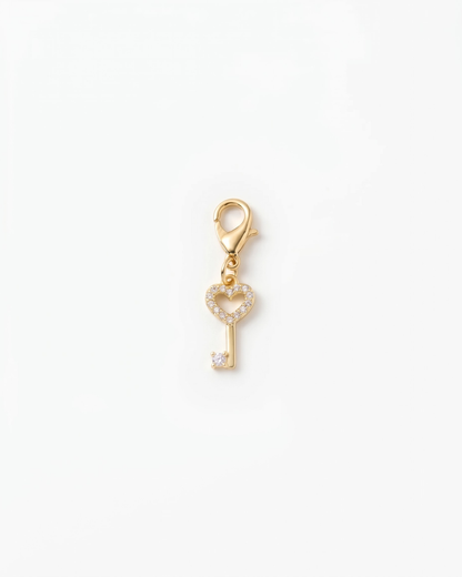 Golden and zirconia charm with lobster hook showing a heart key