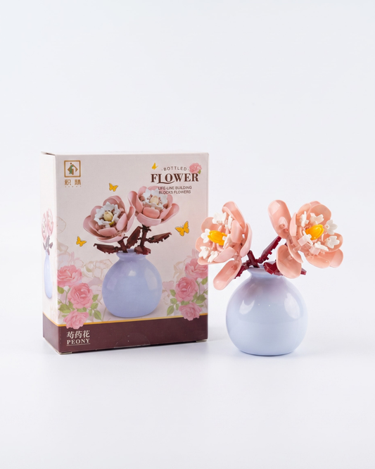 Mini building block flower arrangement in a pastel vase for bookshelf décor and home styling.