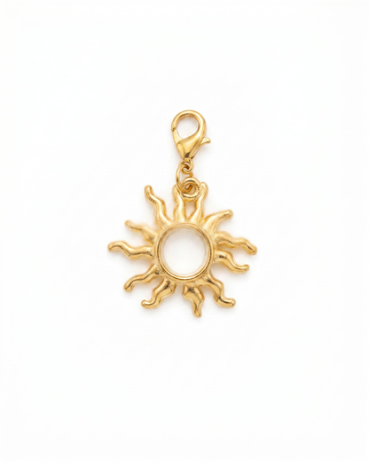 Golden charm with lobster hook showing a sun with squiggly lines