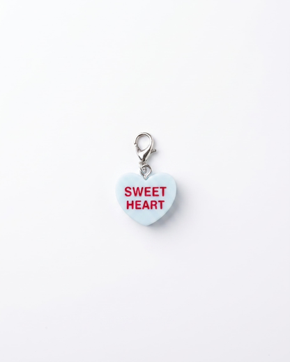 heart shape resin charm on silver lobster clasp that reads sweet heart