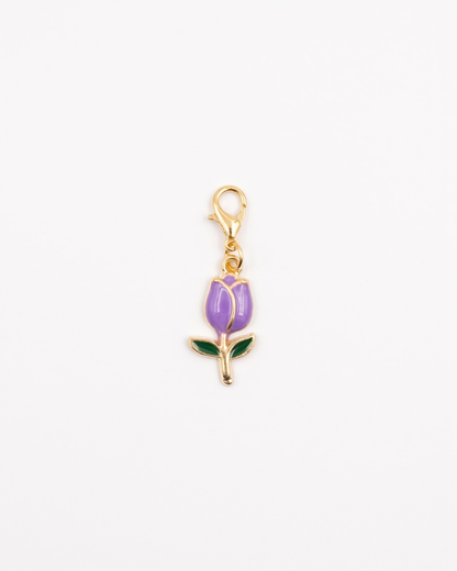 Golden and enamel charm with lobster hook showing a purple tulip